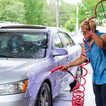 iamge of man car washing